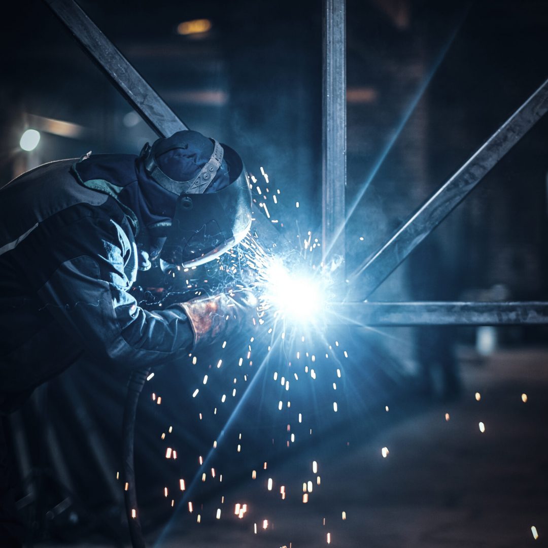 Welding work with metal construction at busy metal factory